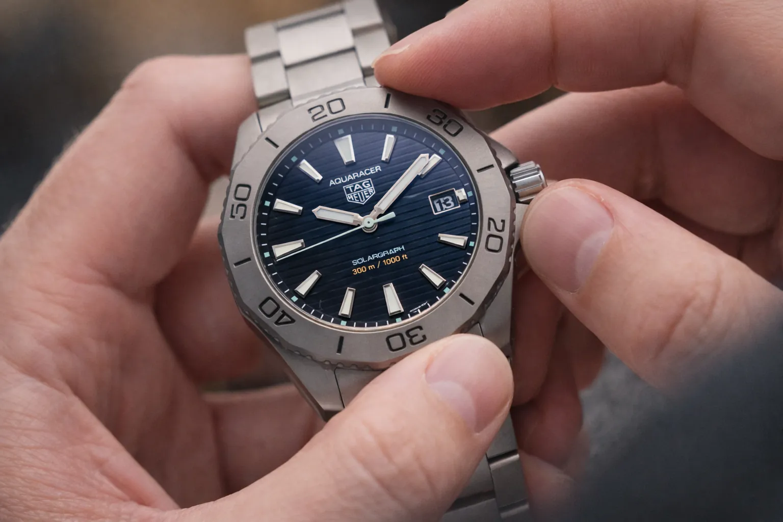 Hand adjusting the crown on a Tag Heuer Aquaracer replica watch showing daily winding and time-setting use