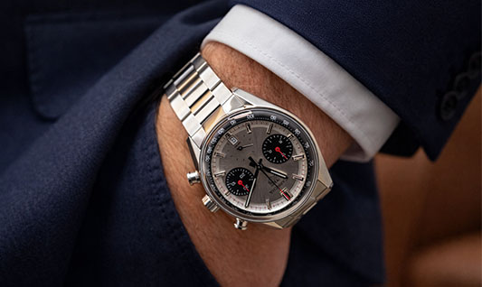 Tag Heuer Carrera chronograph watch with silver dial and stainless steel bracelet on wrist