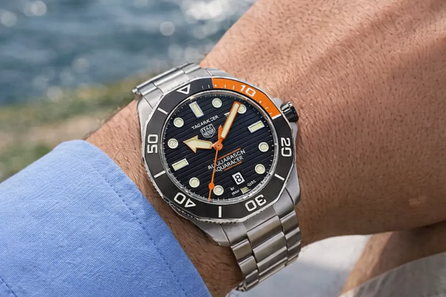 Tag Heuer Aquaracer watch with black dial and orange bezel