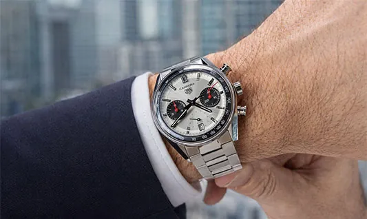 Tag Heuer Carrera chronograph watch with silver dial and stainless steel bracelet on wrist