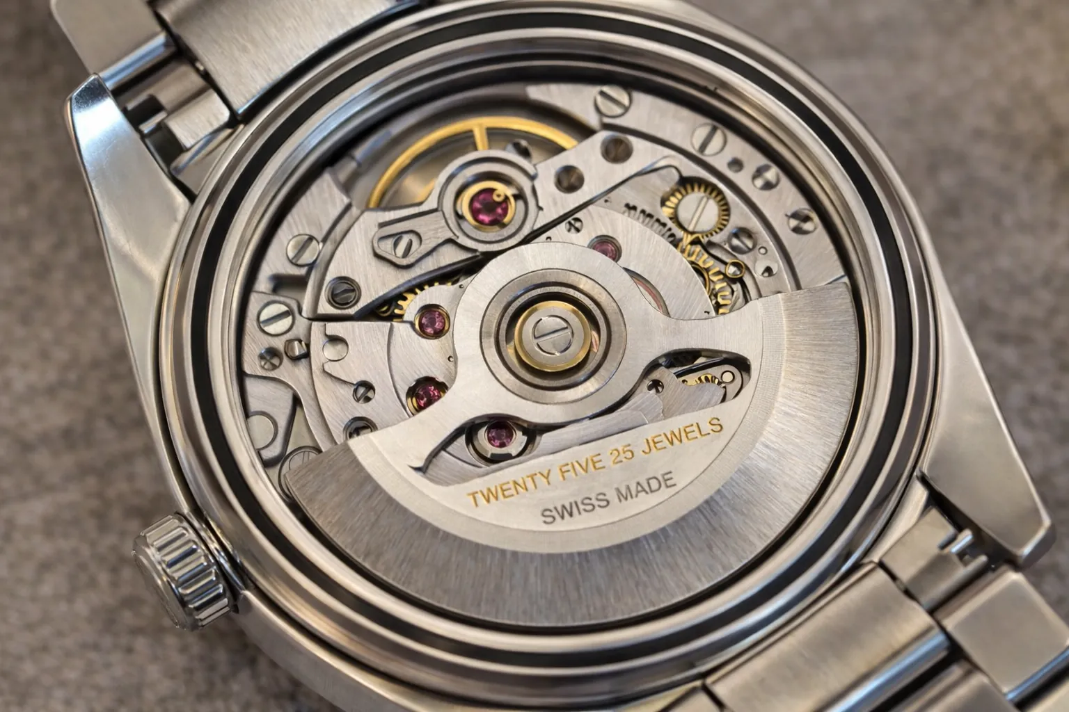 automatic watch movement inside replica watch showing rotor and gears